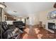 Living room with hardwood floors, fireplace, and access to kitchen at 1411 Ladora Dr, Charlotte, NC 28262