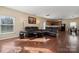 Spacious living room with hardwood floors and a view into the kitchen at 1411 Ladora Dr, Charlotte, NC 28262