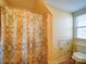 Simple bathroom with patterned shower curtain and tile floor at 148 Tetbury Ne Ave, Concord, NC 28025