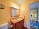 Small bathroom with granite vanity and a large mirror at 148 Tetbury Ne Ave, Concord, NC 28025