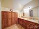 Double vanity bathroom with granite countertop and wood cabinets at 148 Tetbury Ne Ave, Concord, NC 28025