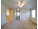 Spacious bedroom with ceiling fan, carpet, and access to hallway at 148 Tetbury Ne Ave, Concord, NC 28025