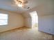 Bright bedroom with ceiling fan and neutral carpeting at 148 Tetbury Ne Ave, Concord, NC 28025