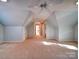 Large bonus room, carpet, and ceiling fan at 148 Tetbury Ne Ave, Concord, NC 28025