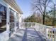 Back deck with white railing, offering a view of the wooded backyard at 148 Tetbury Ne Ave, Concord, NC 28025