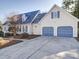 Two-story home featuring a two-car garage and neatly landscaped yard at 148 Tetbury Ne Ave, Concord, NC 28025