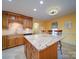 Kitchen with granite island and wood cabinets at 148 Tetbury Ne Ave, Concord, NC 28025