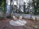 Relaxing backyard seating area with two Adirondack chairs on a round stone patio at 1509 Briar Creek Rd # B, Charlotte, NC 28205