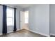 Bedroom with hardwood floors, with two windows with curtains, and a white door at 1509 B Briar Creek Rd, Charlotte, NC 28205