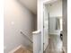 Hallway view leading to a bedroom with modern wood-look flooring at 1509 Briar Creek Rd # B, Charlotte, NC 28205