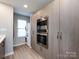 Conveniently located laundry area with stacked washer and dryer and built-in storage at 1509 B Briar Creek Rd, Charlotte, NC 28205