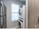 Modern laundry area with stacked washer and dryer, and a window for natural light at 1509 Briar Creek Rd # B, Charlotte, NC 28205