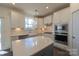 Kitchen with white cabinets, farmhouse sink, and quartz countertops at 1540 Striped Bass Ln, Clover, SC 29710