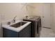 Convenient laundry room with washer, dryer, and utility sink at 1540 Striped Bass Ln, Clover, SC 29710