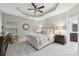 Main bedroom with tufted headboard, ceiling fan, and ensuite bathroom at 16341 Autumn Cove Ln, Huntersville, NC 28078