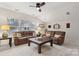 Bright bonus room featuring two sofas, a coffee table, and ample natural light at 16341 Autumn Cove Ln, Huntersville, NC 28078