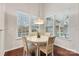 Breakfast nook with a round table and four chairs, overlooking the backyard at 16341 Autumn Cove Ln, Huntersville, NC 28078