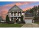 Brick two-story house with a large front porch and landscaped yard at 16341 Autumn Cove Ln, Huntersville, NC 28078