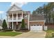 Brick two-story house with a two car garage and landscaped front yard at 16341 Autumn Cove Ln, Huntersville, NC 28078