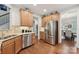 Modern kitchen with stainless steel appliances and light wood cabinets at 16341 Autumn Cove Ln, Huntersville, NC 28078