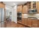 Kitchen features double oven, gas cooktop and glass-front cabinets at 16341 Autumn Cove Ln, Huntersville, NC 28078