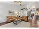 Open living room with hardwood floors, a staircase, and a view into the kitchen at 16341 Autumn Cove Ln, Huntersville, NC 28078