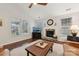 Living room with hardwood floors, fireplace, and large windows at 16341 Autumn Cove Ln, Huntersville, NC 28078