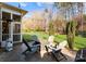 Spacious patio with seating area and fire pit, overlooking a grassy yard at 18621 Rollingdale Ln, Davidson, NC 28036