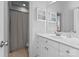 Modern bathroom with white vanity, shower, and updated fixtures at 18621 Rollingdale Ln, Davidson, NC 28036