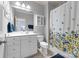 Clean bathroom with a shower/tub combo and floral shower curtain at 18621 Rollingdale Ln, Davidson, NC 28036