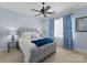 Comfortable bedroom with a plush bed, blue curtains, and ceiling fan at 18621 Rollingdale Ln, Davidson, NC 28036