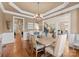 Formal dining room with hardwood floors, chandelier, and large windows at 18621 Rollingdale Ln, Davidson, NC 28036