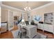 Bright home office with built-in shelving, hardwood floors, and French doors at 18621 Rollingdale Ln, Davidson, NC 28036