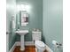 Stylish powder room with pedestal sink and updated fixtures at 18621 Rollingdale Ln, Davidson, NC 28036