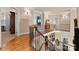 Upstairs hallway with hardwood floors and an open staircase at 18621 Rollingdale Ln, Davidson, NC 28036