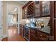 Elegant wet bar with wine rack, beverage cooler, and granite countertop at 18621 Rollingdale Ln, Davidson, NC 28036