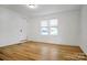 Spacious bedroom with hardwood floors and large window at 203 Linwood Rd, Kings Mountain, NC 28086