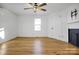 Bright bedroom with hardwood floors, ceiling fan, and fireplace at 203 Linwood Rd, Kings Mountain, NC 28086