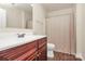 A bathroom features a cherry vanity with cultured marble countertop and a shower-tub combination at 208 Lakewood Ave, Charlotte, NC 28208