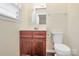 Bathroom featuring a modern vanity with abundant storage and a comfort height toilet at 208 Lakewood Ave, Charlotte, NC 28208