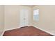 A bedroom with wood-look floors features a window and a closet with bi-fold doors at 208 Lakewood Ave, Charlotte, NC 28208