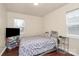 A bedroom with wood-look floors features a bed, window and closet at 208 Lakewood Ave, Charlotte, NC 28208