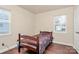 A bedroom with wood-look floors features a bed, window and closet at 208 Lakewood Ave, Charlotte, NC 28208