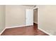 A bedroom with wood-look floors features a door to the hallway and a closet at 208 Lakewood Ave, Charlotte, NC 28208