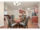 An open dining area features a glass table with four chairs and is adjacent to the kitchen and living room at 208 Lakewood Ave, Charlotte, NC 28208