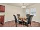 The dining room has a glass-top table, seating for four, and lots of natural light at 208 Lakewood Ave, Charlotte, NC 28208