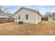 View of home's rear exterior, showing siding, windows, and air conditioning unit at 208 Lakewood Ave, Charlotte, NC 28208