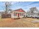 Charming single-story home with a red and beige exterior, and well-manicured landscaping at 208 Lakewood Ave, Charlotte, NC 28208