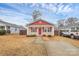 Charming single-story home with a red roof, siding, and landscaped front yard at 208 Lakewood Ave, Charlotte, NC 28208