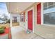 Charming front porch with red door and shutters, offering a welcoming entrance at 208 Lakewood Ave, Charlotte, NC 28208